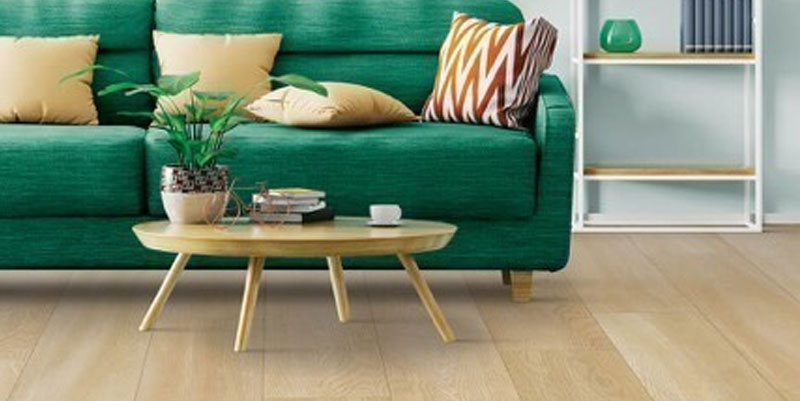 Green sofa on Laminate floor | DeHaan Tile & Floor Covering